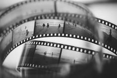 several film strips with people walking on the beach in the background and blurry image