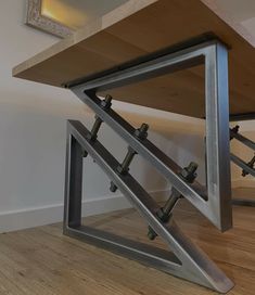 a wooden table with metal brackets on it