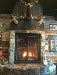 the fireplace is decorated with deer heads and antlers