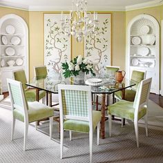 a dining room table with green chairs around it