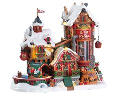 a christmas village is shown with snow on the roof