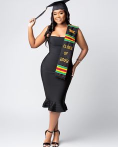 a woman in a graduation gown and cap is posing for the camera with her diploma