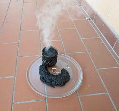 an object is on the ground with steam coming out of it's top and bottom