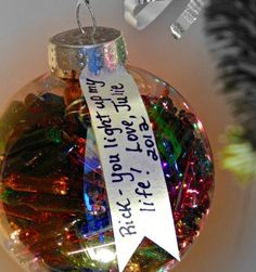 a glass ornament with a ribbon hanging from it's side and the words recycled lights written on it