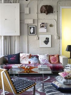 a living room filled with furniture and pictures on the wall