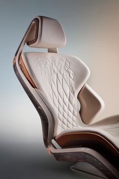 an office chair made out of wood and white leather, with the seat folded back