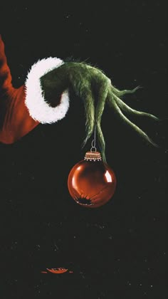 an ornament hanging from a christmas tree in the shape of a santa hat