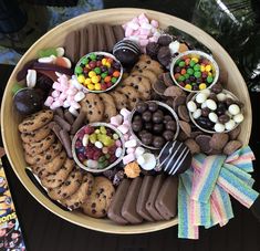 a platter filled with lots of different types of candies and chocolate covered cookies