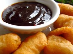 some fried food on a plate with dipping sauce