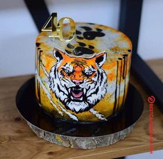 a cake decorated with an image of a tiger on the front and number four on the back