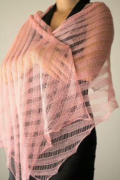 a woman is wearing a pink shawl