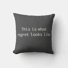 a black pillow with the words, this is what regret looks like on it