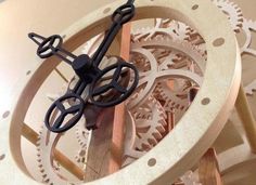 there is a clock made out of wood and some scissors on the top of it