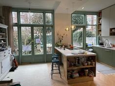 an open kitchen with lots of counter space and large glass doors leading to the back yard