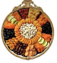 an assortment of fruits and nuts in a golden frame