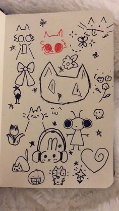 an open notebook with drawings on it