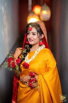 a woman dressed in yellow and red poses for the camera