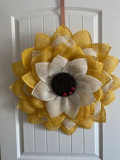 a white door with a yellow and black flower on it's front entrance handle