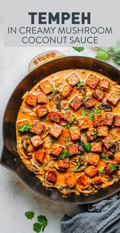 an overhead view of a creamy mushroom and coconut sauce in a cast iron skillet