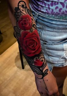 a woman's arm with roses on it