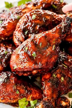 grilled chicken wings with garnishes and parsley on a white plate