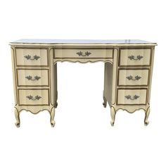 an antique desk with marble top and drawers