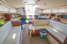 the inside of a sailboat with lots of seating and storage space on it's sides