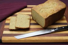 a loaf of bread sitting on top of a cutting board next to a knife