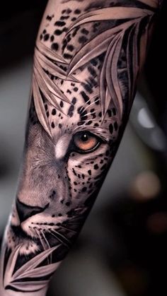 a black and white tattoo with a leopard's face on the left arm,