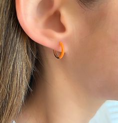 Dainty 14K Round Orange Enamel Hoop Earrings. The Leading Trend In Jewelry Today These Pretty Everyday Tiny Huggie Hoop Earrings Are A Must Have! Perfect For 2nd Or 3rd Earring Hole. Jewelry Comes In A Cute Gift Box Ready To Present.  -All Jewelry Is New And Inspected For Quality Assurance.  -Jewelry Is Crafted In Genuine High Quality 14K Gold. -We Do Not Sell Gold Plated.  Product Detail:  Metal: 14k yellow gold with Orange Enamel Width: 2mm Weight: 1.5 grams Length: 13mm Closure: Latch Back  -Feel Free To Ask Me Any Questions Or Concerns You May Have.  Follow Me @sarakayjewelry Thank You For Visiting My Shop. Orange Small Hoop Earrings For Summer, Small Hoop Earrings Orange Gift, Trendy Small Hoop Orange Jewelry, Trendy Small Hoop Orange Earrings, Minimalist Orange Round Jewelry, Earring Hole, Cute Gift Boxes, Sell Gold, Enamel Earrings