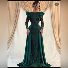 This Dress Is From The Ari Art Designers, It Is A Beautiful Dark Green Color, And Is Custom Made. The Dress Was Only Worn Once. The Dress Is Heavily Beaded And Is Fully Covered So Is Perfect For Hijab. The Measurements Used For The Dress Are, Bust-103.5 Cm Waist- 82 Cm Hips- 116 Cm Height 160 Cm. Elegant Prom Dresses Unique Fitted, Long Sleeve Ruffled Gown For Gala, Cocktail Dress With Sweep Train And Long Sleeves, Cocktail Long Sleeve Dress With Sweep Train, Long Sleeve Gown With Ruffles, Green Long Sleeve Dress For Banquet, Green Ruffled Evening Dress, Evening Gown With Ruffles And Long Sleeves, Green Long Dress For Banquet