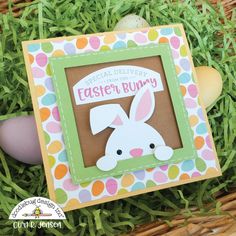 a card with an easter bunny on it and eggs in the grass next to it