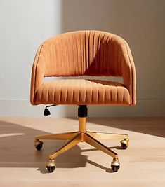 an orange chair sitting on top of a wooden floor