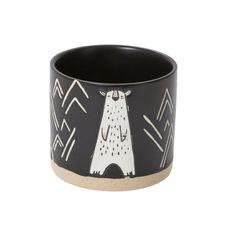 a black and white cup with a bear on it