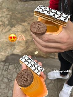 two people holding cookies and peanut butter sandwiches