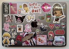 an apple laptop covered in stickers and magnets with the words life is only one