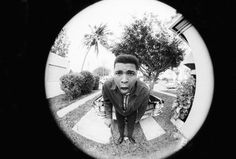 a black and white photo of a man sticking his tongue out in front of the camera