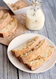 slices of bread on a plate next to a jar of milk