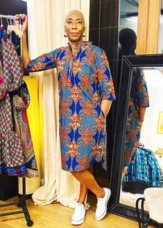 "An African print shirt dress in a contemporary pattern. It has a chinese collar with buttons for closure. It has a dipped back hem with 3/4 sleeves and side pockets. It is fully lined. It is a trans-seasonal piece;it could be worn with jeans or leggings either long or ankle boots in cooler weather as in the image or on it's own on warmer days. Belt available here https://www.etsy.com/uk/listing/872982464/faux-leather-wide-belt-with-stitching?ga_search_query=Belt&ref=shop_items_search_1&crt=1 The model is 5ft 9\" Length is 40\" Care Handwash in cool water. Dry away  from direct sunlight. Iron on medium heat." Ankara Shirt Dress For Women, Sesotho Traditional Dresses, Ankara Shirt Dress, African Shirt Dress, Kitenge Designs, African Print Shirt, Fashion Dresses Formal, Contemporary Pattern, Print Shirt Dress