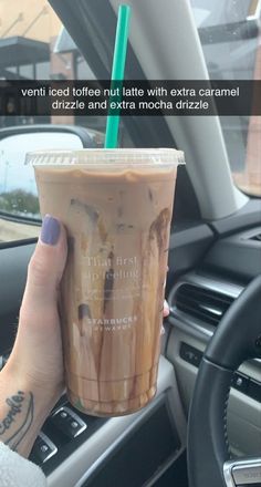 a woman holding up a cup of coffee in her hand with the caption that reads, ventted iced coffee nutties with extra caramel drizze and extra mocha