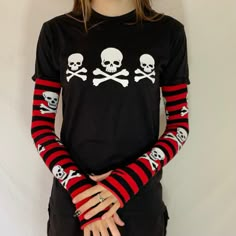 This punky gothic top has rhinestone embellishments on the skulls 100% cotton t-shirt with an Acidcore label.  Red & black skeleton stripe sleeves sewn into the top with thumb holes & fingerless gives this top grunge goth vibes. The sleeves are also available white & black with skulls About Me:  Acidcore is my store based in London. All my items are hand printed with hand made transfers and some are hand embellished. My designs are inspired by different genres, gothic, fairycore, cottagecore, punk, indie. Gothic Skull Print T-shirt For Fall, Fitted Skull Print Top For Streetwear, Long Sleeve Halloween T-shirt For Alternative Fashion, Gothic Long Sleeve Cotton T-shirt, Winter Skull Print Cotton Tops, Fitted Graphic Print Emo Tops, Alternative Long Sleeve Tops With Skull Print, Punk Style Winter Tops For Alternative Fashion, Winter Cotton Tops With Skull Print