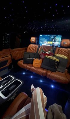 the interior of a luxury car with leather seats and accessories on display at an event