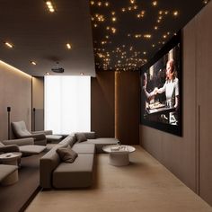 a room with couches and a large screen on the wall