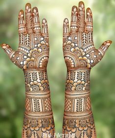 two hands with hendi designs on them