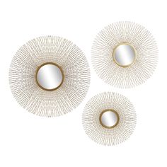 three white and gold circular mirrors on a white background, each with an intricate design