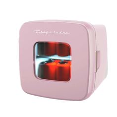 a pink toy oven with two red candles in it's front and the words play time on its side