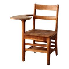 a wooden chair with a small table on the backrest and seat, against a white background