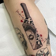 a woman's leg with a knife tattoo on it