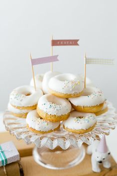 there are many donuts on the plate with flags in them and one is white