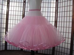 "This listing is for a custom version of the pink tulle petticoat shown in the photos. The waist area is as fitted as possible so that it just fits over the largest part of the body. The waistband is .5\" (1,25cm) wide elastic covered with satin for comfort. The waist area has 2 layers of tulle and is 5\" (12,5cm) long in the photo but can be customized to be shorter or longer, depending on your needs -- just let me know how long the fitted portion needs to be for your dress or else I'll make it Stretch Pink Dress With Tulle Skirt, Pink Stretch Dress With Tulle Skirt, Fitted Crinoline Petticoat For Party, Pink Stretch Tulle Petticoat, Fitted Full Skirt Petticoat For Party, Fitted Full Tulle Skirt Petticoat, Stretch Pink Tulle Petticoat, Fitted Full Tulle Petticoat, Fitted Organza Petticoat With Ruffles